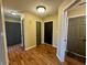 Inviting hallway with wood-look flooring and neutral walls, leading to multiple rooms and closet spaces at 7156 Long Shore Cir, Indianapolis, IN 46217