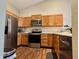 The kitchen features stainless steel appliances, hardwood floors, and light colored cabinetry at 7156 Long Shore Cir, Indianapolis, IN 46217