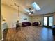 Spacious living room featuring skylights, hardwood floors, and a glass patio door for natural light at 7156 Long Shore Cir, Indianapolis, IN 46217