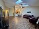 A living room with skylights which opens to the kitchen and dining area, featuring wood floors at 7156 Long Shore Cir, Indianapolis, IN 46217