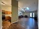 A living room which opens to the kitchen and dining area, featuring wood floors and neutral walls at 7156 Long Shore Cir, Indianapolis, IN 46217
