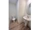 Powder room with wood floor, pedestal sink and classic toilet at 737 Madelyn Dr, Carmel, IN 46032