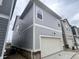Two-story home with vinyl siding and a one-car attached garage at 737 Madelyn Dr, Carmel, IN 46032