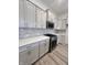 A kitchen with sleek white cabinets, stainless steel appliances, and a modern backsplash at 737 Madelyn Dr, Carmel, IN 46032
