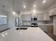 A kitchen island offers a sink and countertop space, surrounded by modern cabinets and appliances at 737 Madelyn Dr, Carmel, IN 46032