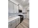 A kitchen with sleek white cabinets, stainless steel appliances, and a modern backsplash at 737 Madelyn Dr, Carmel, IN 46032