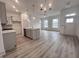 Open-concept living space featuring hardwood floors, large windows and recessed lighting at 737 Madelyn Dr, Carmel, IN 46032