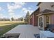 Side view of the back exterior, highlighting the deck, lawn, and architectural details of the home's facade and landscaping at 7619 Bluebird Ct, Brownsburg, IN 46112