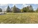 Lush backyard with mature trees and ample lawn space, showcasing the property's spacious outdoor area at 7619 Bluebird Ct, Brownsburg, IN 46112