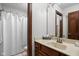 Bathroom showcasing vanity with tan countertop and shower with a white curtain at 7619 Bluebird Ct, Brownsburg, IN 46112