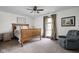 Comfortable bedroom with wood frame bed, patterned curtains, and reading chair at 7619 Bluebird Ct, Brownsburg, IN 46112