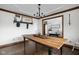 Elegant dining room featuring a wood table, decorative chandelier, and view into the entryway at 7619 Bluebird Ct, Brownsburg, IN 46112