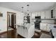 Bright kitchen featuring white cabinets, granite countertops, stainless steel appliances and a decorative tile backsplash at 7619 Bluebird Ct, Brownsburg, IN 46112
