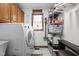 Functional laundry room with washer, dryer, storage, and window at 7619 Bluebird Ct, Brownsburg, IN 46112