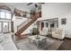 This living room features hardwood floors and a view of the staircase, dining and front door at 7619 Bluebird Ct, Brownsburg, IN 46112