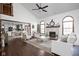 Bright living room with fireplace, vaulted ceiling, hardwood floors, and open to dining and kitchen at 7619 Bluebird Ct, Brownsburg, IN 46112