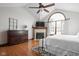 Spacious main bedroom with a fireplace, vaulted ceiling, arched window, and ceiling fan at 7619 Bluebird Ct, Brownsburg, IN 46112