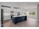 Modern kitchen boasts white cabinets, stainless steel appliances, a large island, and ample counter space at 7707 Walker Dr, Avon, IN 46123