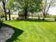 Expansive backyard with lush green grass, mature trees, and a quaint shed at 7987 Teal Dr, Coatesville, IN 46121