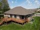 Spacious backyard featuring a wooden deck, lush lawn, and exterior brickwork at 7987 Teal Dr, Coatesville, IN 46121