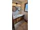 Bright bathroom with dual sinks, wood cabinetry and natural light at 7987 Teal Dr, Coatesville, IN 46121