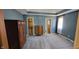 Spacious bedroom features a neutral carpet, en-suite bathroom, and a large window for natural light at 7987 Teal Dr, Coatesville, IN 46121