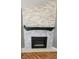 Close-up of a contemporary fireplace with a stone surround at 7987 Teal Dr, Coatesville, IN 46121
