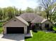 Attractive brick home featuring an attached garage and verdant front yard at 7987 Teal Dr, Coatesville, IN 46121
