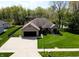 Well-maintained home with a brick facade, attached garage, and a large driveway at 7987 Teal Dr, Coatesville, IN 46121