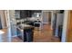 Full kitchen view with stainless steel appliances and black cabinetry at 7987 Teal Dr, Coatesville, IN 46121