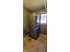 Stacked washer and dryer setup in laundry room with a tiled floor at 7987 Teal Dr, Coatesville, IN 46121