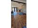 Comfortable living room featuring hardwood floors, a stone fireplace, and natural light at 7987 Teal Dr, Coatesville, IN 46121