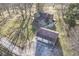Aerial view of the home and garage, plus a back patio area with white Adirondack chairs at 8090 E 550 S, Zionsville, IN 46077