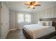 Cozy bedroom with a ceiling fan, natural light, and a decorative wood paneled wall at 8090 E 550 S, Zionsville, IN 46077