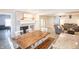 Inviting dining area with a rustic wood table, stylish brick fireplace, and seamless access to the living room at 8090 E 550 S, Zionsville, IN 46077