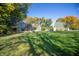 Beautiful home exterior with mature trees and lush green lawn on a sunny day at 8090 E 550 S, Zionsville, IN 46077