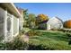 Home exterior showcasing green siding, landscaped yard, and a detached garage at 8090 E 550 S, Zionsville, IN 46077
