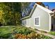 Exterior view of a green home with well-maintained landscaping and mature trees at 8090 E 550 S, Zionsville, IN 46077