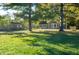 Spacious property featuring green home, garage, and expansive lawn with mature trees at 8090 E 550 S, Zionsville, IN 46077