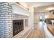 Charming fireplace with a decorative mantle and rustic white brick surround in an open-concept living space at 8090 E 550 S, Zionsville, IN 46077