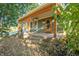 Charming front porch with wood pillars and accents on a home surrounded by mature trees at 8090 E 550 S, Zionsville, IN 46077
