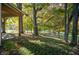 View from the covered porch looking out to mature trees and lush greenery at 8090 E 550 S, Zionsville, IN 46077