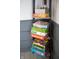 A corner shelf displaying a colorful collection of board games, adding a fun and decorative touch to the room at 8090 E 550 S, Zionsville, IN 46077