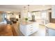 Bright, open kitchen featuring an island, granite counters, stainless appliances, and views into the living room at 8090 E 550 S, Zionsville, IN 46077