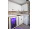 This kitchenette has white cabinets, light countertops, a wood backsplash, and a beverage cooler at 8090 E 550 S, Zionsville, IN 46077