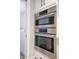 Sleek, stainless steel wall oven with a microwave and oven combination, next to a laundry area at 8090 E 550 S, Zionsville, IN 46077