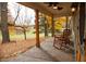 Relaxing covered porch with wooden rocking chairs overlooking mature trees at 8090 E 550 S, Zionsville, IN 46077