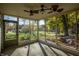 Screened-in porch with ceiling fans, offering views of the yard at 8090 E 550 S, Zionsville, IN 46077
