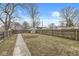 Large fenced backyard with a storage shed and pathway, perfect for outdoor activities and entertaining at 827 N Tacoma Ave, Indianapolis, IN 46201