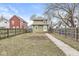 Expansive backyard with a pathway, surrounded by a wooden fence, offering privacy and space at 827 N Tacoma Ave, Indianapolis, IN 46201